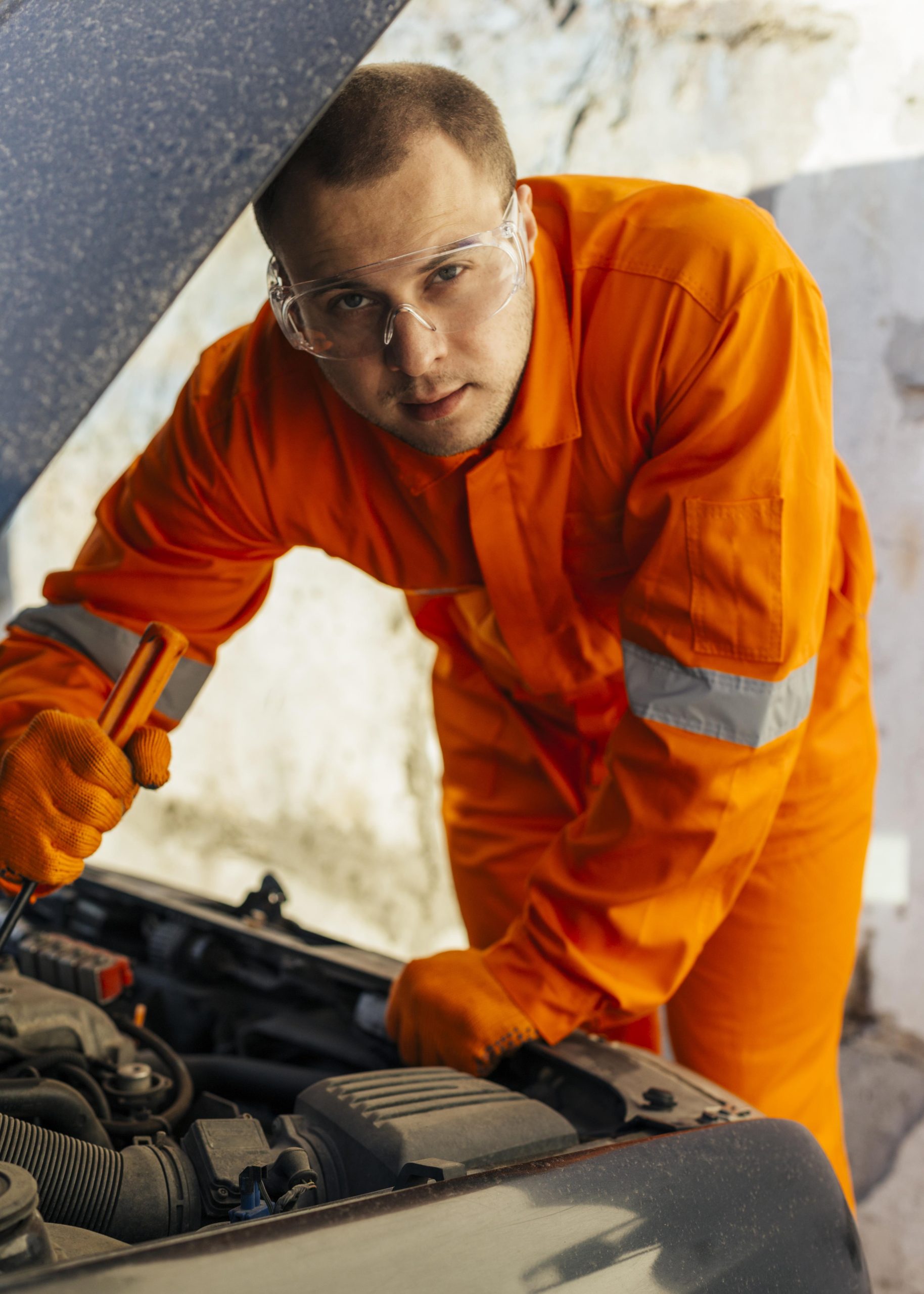 front-view-mechanic-with-protective-glasses-uniform